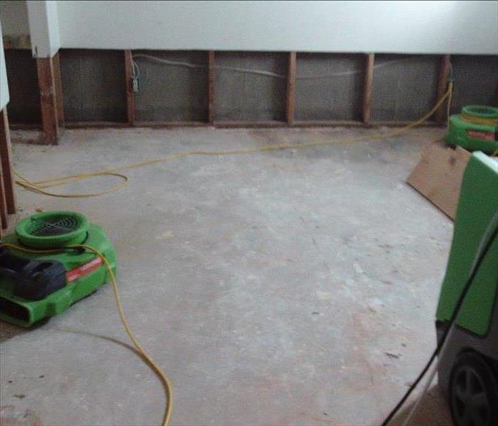 Green SERVPRO equipment drying out a flooded basement