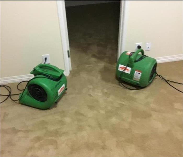 Drying equipment placed in bedroom after suffering water damage. 