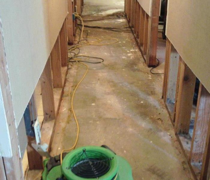 Drying equipment in flood damaged hallway