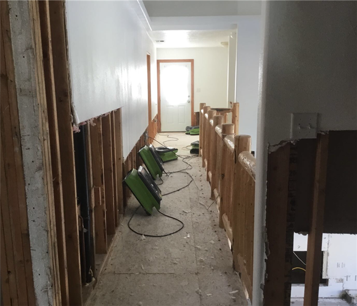 Green air movers drying out hallway and banisters in Cedar City, Utah