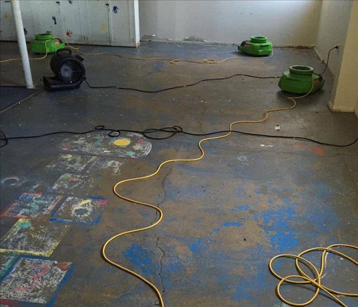 Daycare with carpet lifted and air movers placed